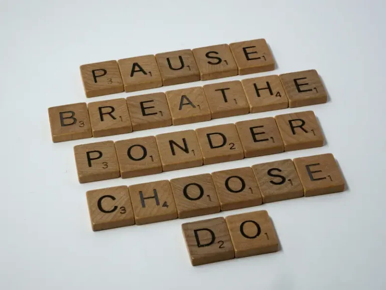 Wooden Scrabble tiles spelling out a mindful behavioral chain to explain why can't I stay consistent with habits long term.
