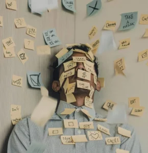 An exhausted man covered in sticky notes, illustrating the mental overwhelm of someone wondering why they can't stick to habits.