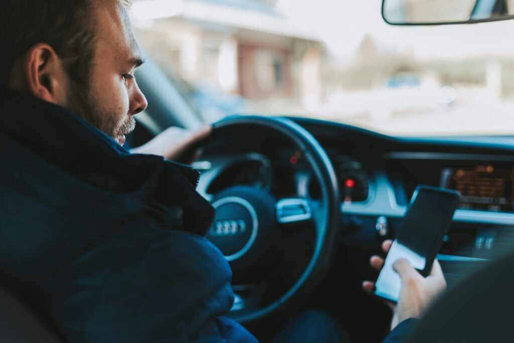 Man driving a vehicle automatically while distracted, illustrating how subconscious