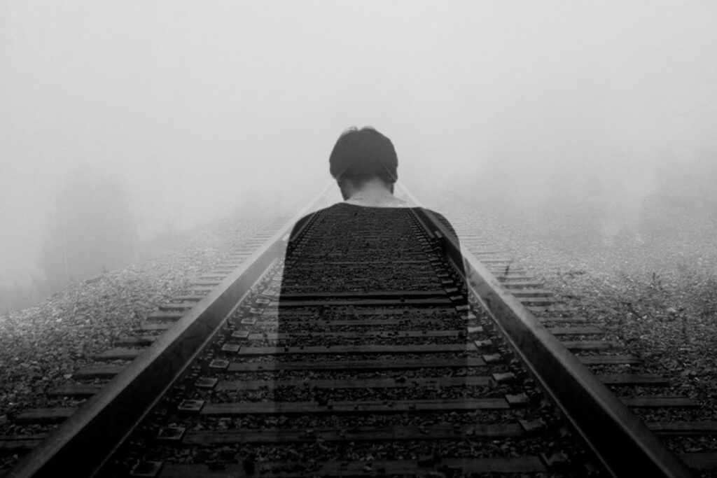 A person experiencing a subconscious self sabotage loop, holding themselves back from success and happiness.