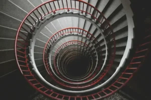 Abstract spiral staircase symbolizing how habits are formed through repeated behavioral patterns and subconscious conditioning.