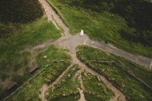 Aerial view of multiple paths meeting at a crossroads in a green landscape