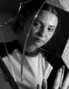 Woman's fragmented reflection representing psychological blind spots and self-perception
