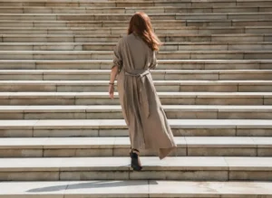 Woman walking up steps, representing identity change and personal growth
