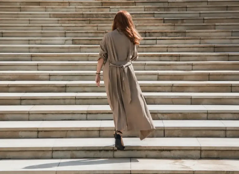Woman walking up steps, representing identity change and personal growth