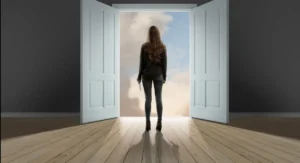 Woman facing an open doorway, representing why change can feel difficult and unfamiliar