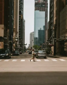 Person walking through a city environment, representing how the environment affects human behavior